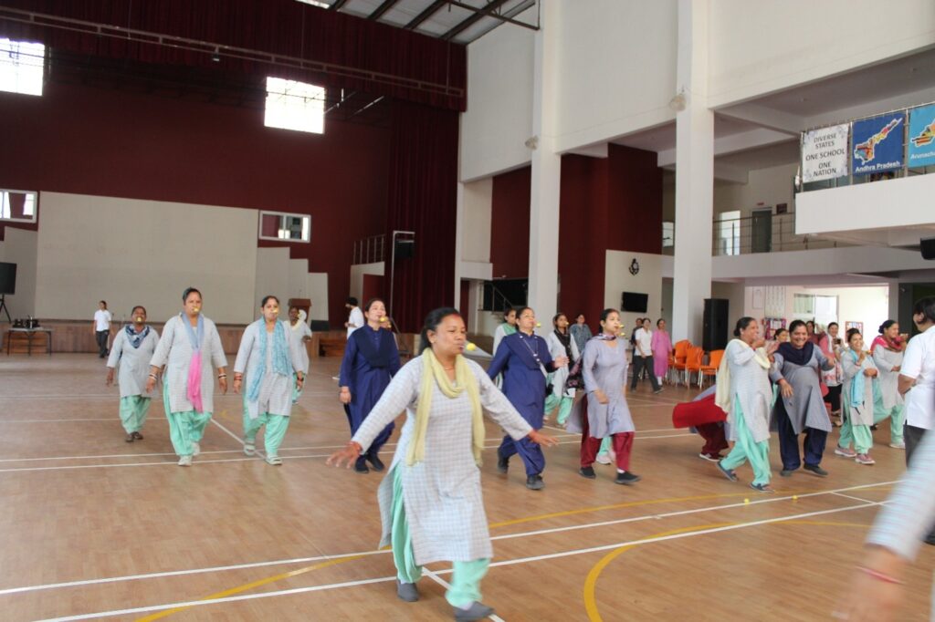 Grade 12 students of Vantage Hall celebrating Labour Day with support staff - best girls boarding school in Dehradun character building.