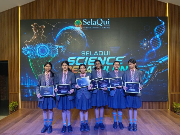 Student delegation holding the Runners-Up trophy at SelaQui Science Decathlon from the best girls boarding school in Dehradun India.