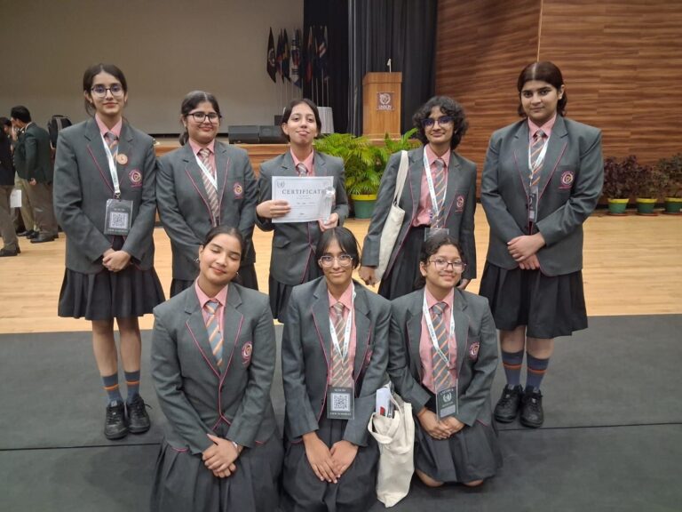 Vantage Hall delegates Anvi Garg, Mannaz, and Khwaish holding their MUN award certificates at the best girls boarding school in Dehradun