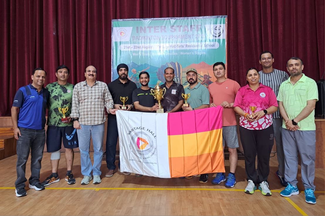 Vantage Hall staff team receiving the Men's Team Championship trophy at the Interstaff Badminton Tournament 2026 - best girls boarding school in Dehradun India