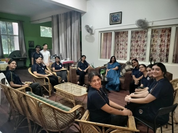 Class XII students engaging in mentorship tea sessions with Ma'am Parmar in the residential lounge at Vantage Hall - best girls boarding school in Dehradun