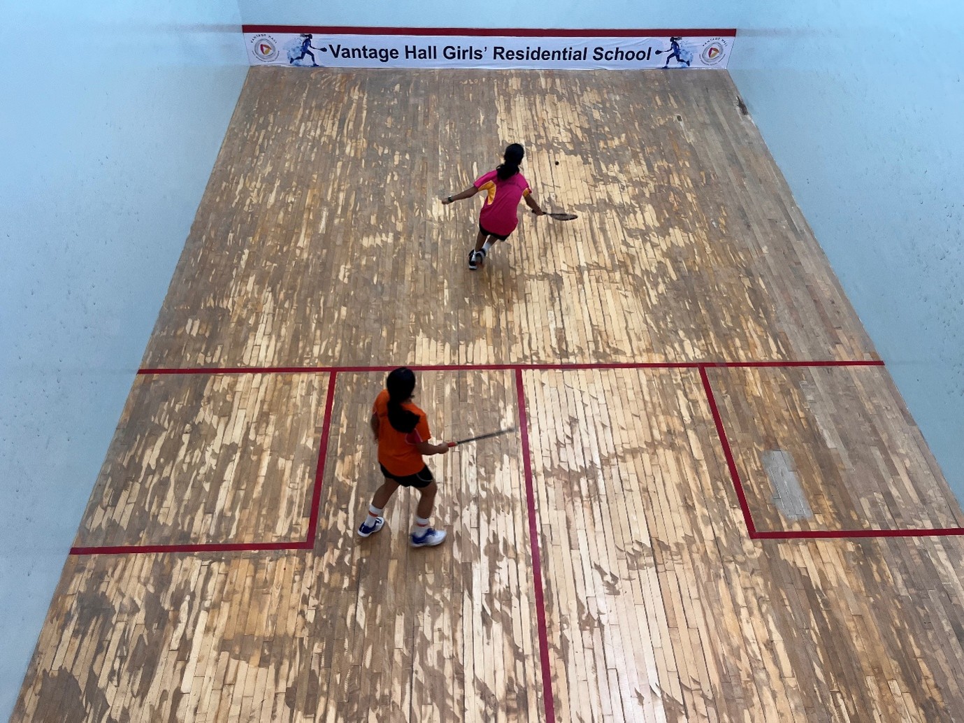 Student-athletes competing on the indoor squash courts during the Inter-House Squash Competition at Vantage Hall - best girls boarding school in Dehradun India