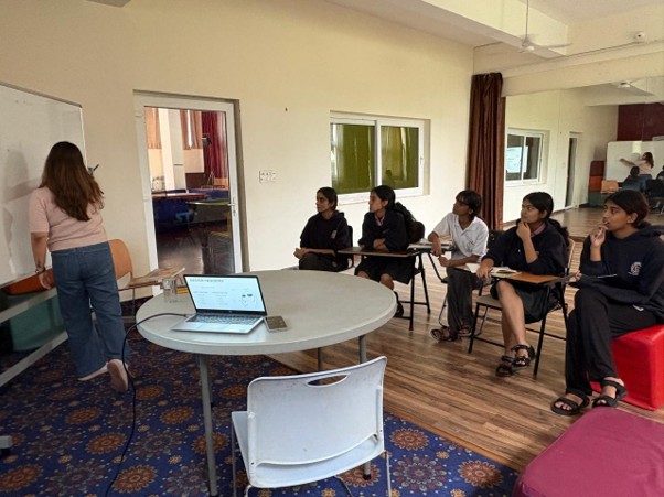 Senior students reviewing creative portfolios with an admissions expert at Vantage Hall - best girls boarding school in Dehradun